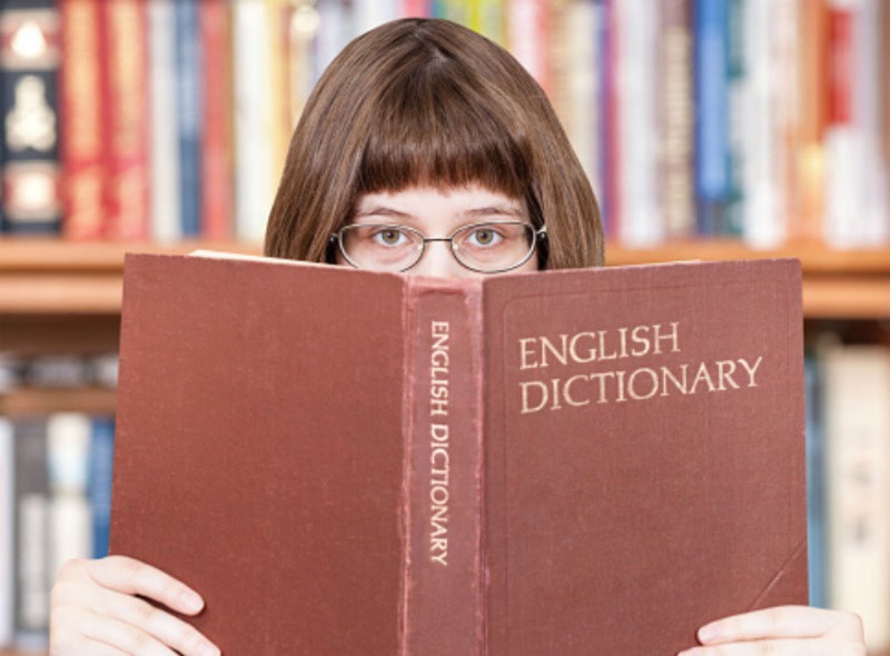 Speak English fluently
An image of a bespectacled girl holding an English dictionary